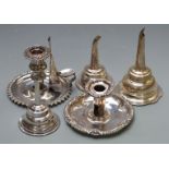 Two 19thC silver plated chambersticks, one by Matthew Boulton, and three wine funnels