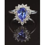 A 14k white gold ring set with a pear cut tanzanite surrounded by diamonds, size M, 3.2g
