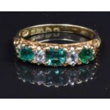 Edwardian 18ct gold ring set with three square cut emeralds and two old cut diamonds, Chester