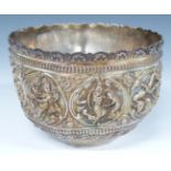 Indian or Burmese white metal bowl with embossed decoration of deities including playing instruments