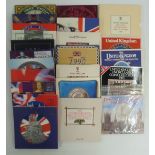 Twenty-three Royal brilliant uncirculated UK coin sets in presentation packs, 1982-2004