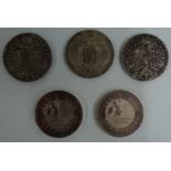 Three Maria Theresa coins and two Millennium £5 crowns