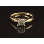 A 9ct gold ring set with diamonds in a square setting, size O, 1.7g