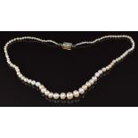 A single strand of 103 natural pearls, the 18ct gold clasp set with diamonds and emeralds, with