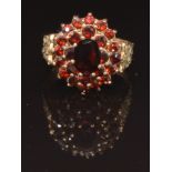 A 9ct gold ring set with a cluster of garnets, size O, 4.1g