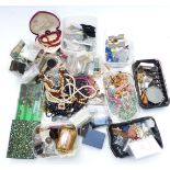 A collection of costume jewellery including beads, vintage brooches, paste, vintage necklaces, etc