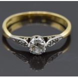 An 18ct gold ring set with a 0.25ct diamond with diamond encrusted shoulders, size M, 1.8g