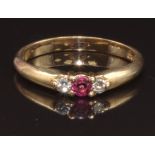 A 9ct gold ring set with a round cut ruby and two round cut diamonds, size N, 2.3g