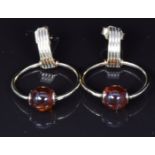 A pair of 9ct gold earrings set with an amber bead to each, 3.1g