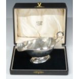 Cased George V hallmarked silver sauce boat, Birmingham 1930, maker Charles S Green & Co Ltd, length