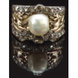 A 19thC ring of pierced phoenix design, set with a natural pearl and rose cut diamonds, size O, 6.