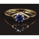 An 18ct gold ring set with a round cut sapphire, size O, 1.6g