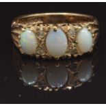 A 9ct gold ring set with three white opal cabochons, size P, 3.5g