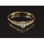 A 9ct gold ring set with a diamond and with diamond encrusted shoulders, size N, 1.6g