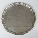 George VI hallmarked silver salver with shaped edge and raised on four feet, Birmingham 1938,