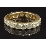 A 14k gold eternity ring set with 18 round cut diamonds, total diamond weight approximately 3.6ct,