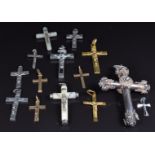 A collection of cross and crucifix pendants including silver, mother of pearl and two 9ct gold, 2.