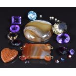 A collection of loose stones including zircon, agate, amethyst, garnet, etc