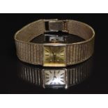 Tissot Stylist 9ct gold ladies wristwatch with black hands, two-tone baton markers, gold dial and