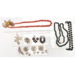 A collection of silver/ white metal filigree brooches, coral necklace, hardstone necklaces and two
