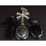 Victorian jet locket opening to reveal a portrait and plaited hair, a Victorian jet pendant, a cross