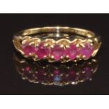 A 9ct gold ring set with five round cut rubies, size N, 2.4g