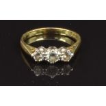 An 18ct gold ring set with three diamonds, size I, 2.1g