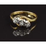 An 18ct gold ring set with three diamonds in a platinum illusion setting, size J, 2.9g