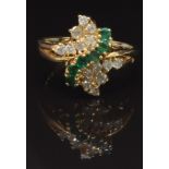 A 14k gold ring set with round cut emeralds and diamonds, size Q, 5g