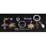A collection of Victorian/ Edwardian pendants and brooches set with amethysts, garnets, etc