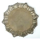 Edward VII hallmarked silver salver with shaped edge and raised on three feet, Sheffield 1909, maker
