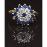 An 18ct gold ring set with diamonds and sapphires in a cluster, size M/N, 4.8g