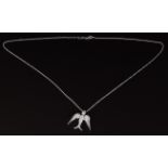 An 18ct white gold pendant in the form of a swallow set with diamonds, 4g