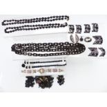 A collection of jet beads, vulcanite necklace, jet buckles, cut steel buckle, French jet buttons,