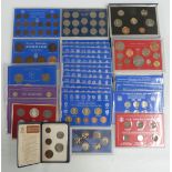 A collection of UK and other coin sets including 1987 cased example, but mostly in flat or