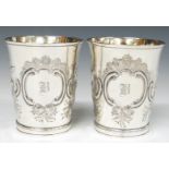 Pair of Georgian hallmarked silver beakers with gilt wash interiors and embossed decoration,