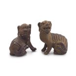 A pair of Chinese stoneware I-shing figures of fu lions, Qing Dynasty, 19th century