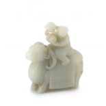 A Chinese carved jade figure of a small boy astride a ram, 19th century