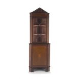 An Edwardian mahogany and inlaid corner cupboard