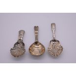 A George IV silver shell caddy spoon, by Taylor & Perry, Birmingham 1830; together with two