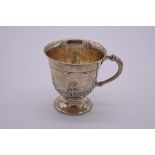 A silver footed mug, by Wakely & Wheeler, London 1923, decorated thistle, 9cm high, 170g.