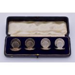 A cased set of four Edwardian silver place markers, by Sampson Mordan & Co, Chester 1907, 105g.