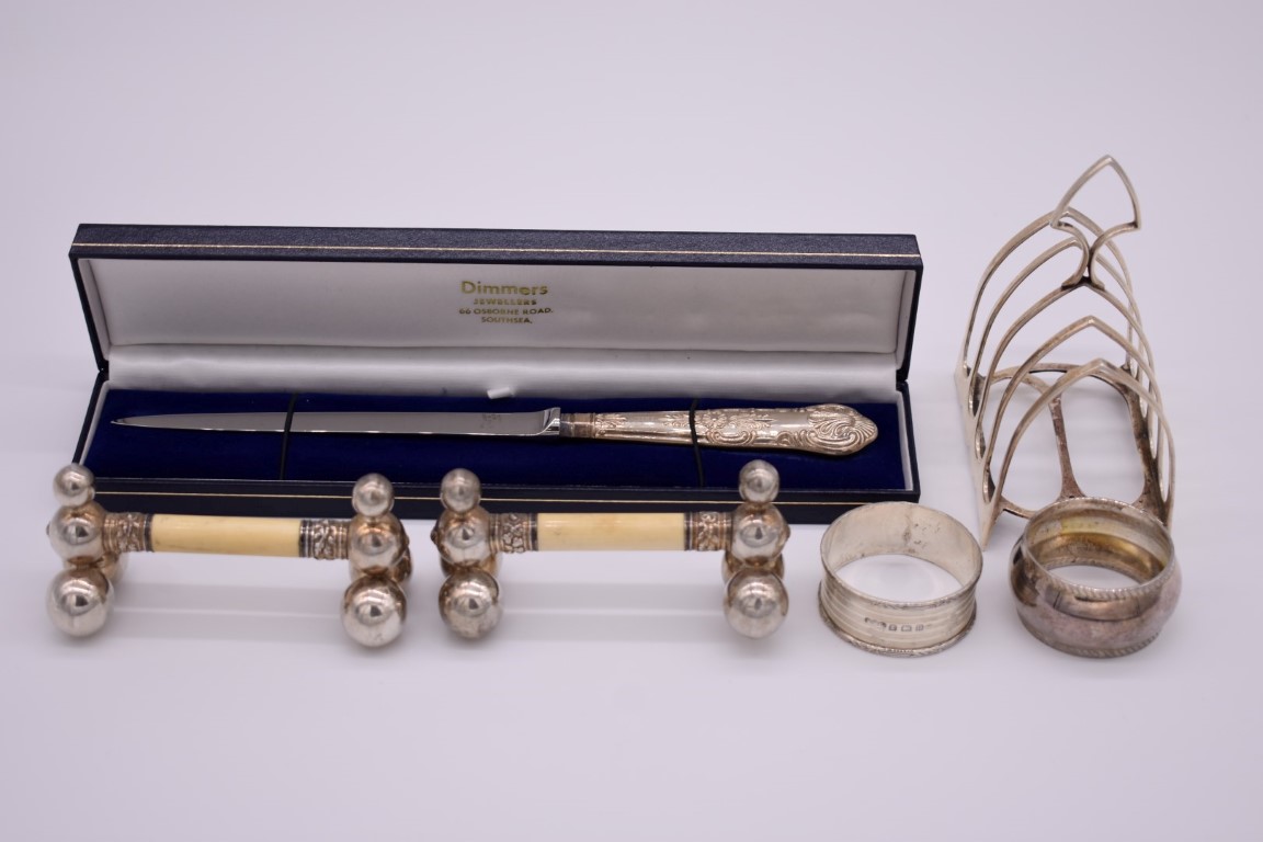 A small quantity of silver and other items, to include a silver toast rack and a cased silver