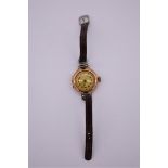 A vintage 9ct gold ladies manual wind wristwatch, on leather strap.