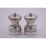 A pair of silver capstan pepper mills, by M C Hersey & Son Ltd, London 1983, 9.5cm high.