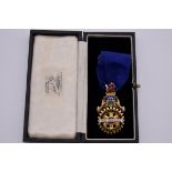 A cased gold and coloured enamel Rotary Club Tottenham Past President neck badge, hallmarked 375,