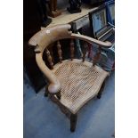 A Victorian walnut and cane seat smokers bow chair.