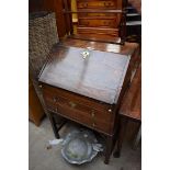 An 18th century elm bureau on stand, 64cm wide.