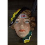 An Art Deco Czechoslovakian pottery wall mask, 20.5cm high, (a.f.).