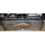 A Newlyn style embossed copper fireplace hood, decorated with a fish, 82cm wide.